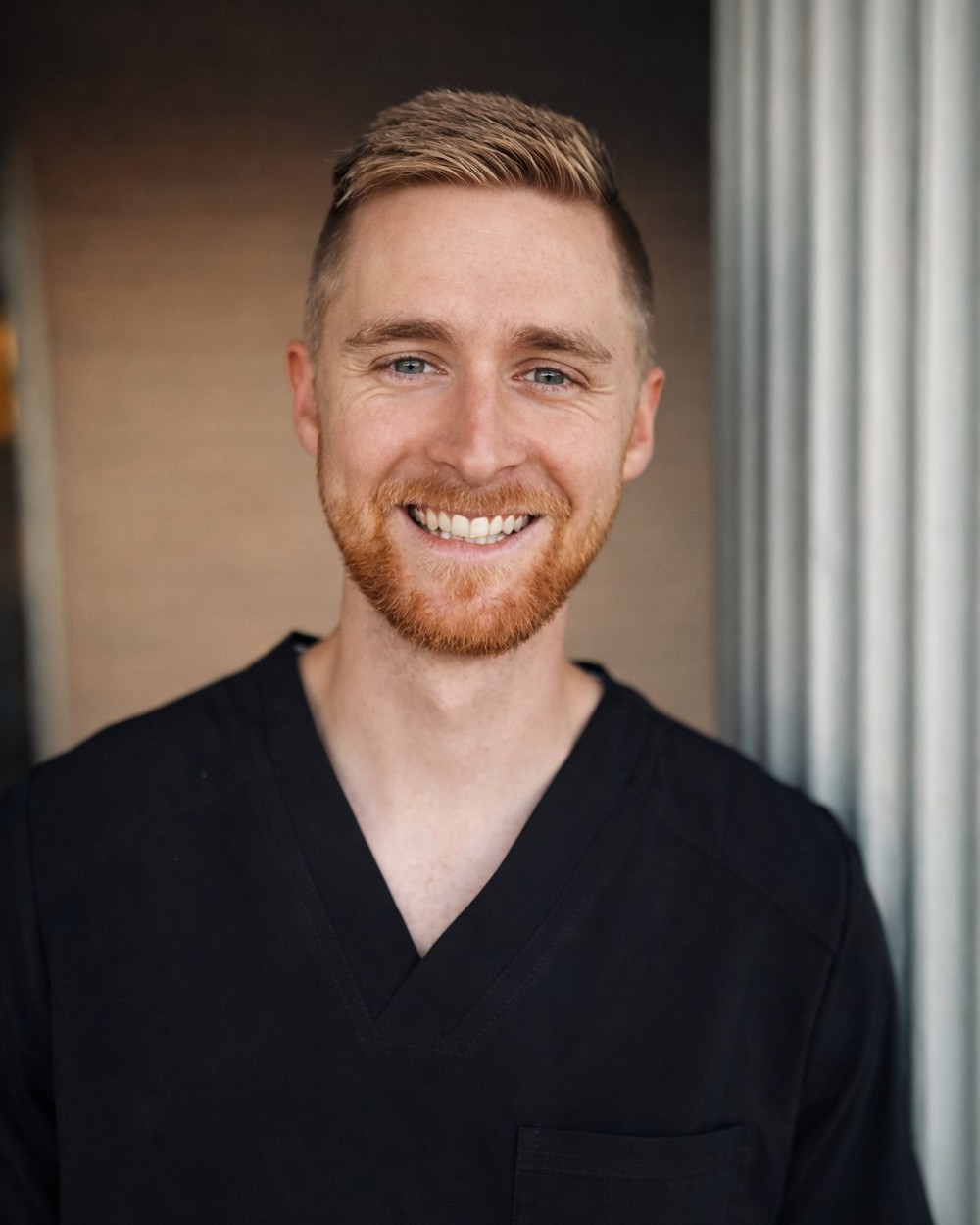 Dr. Dakota Argyle, DDS, in black scrubs — co-owner and dentist at Old Betsy Dental