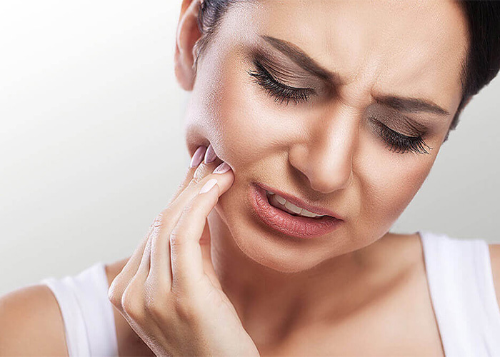 A woman experiencing tooth pain